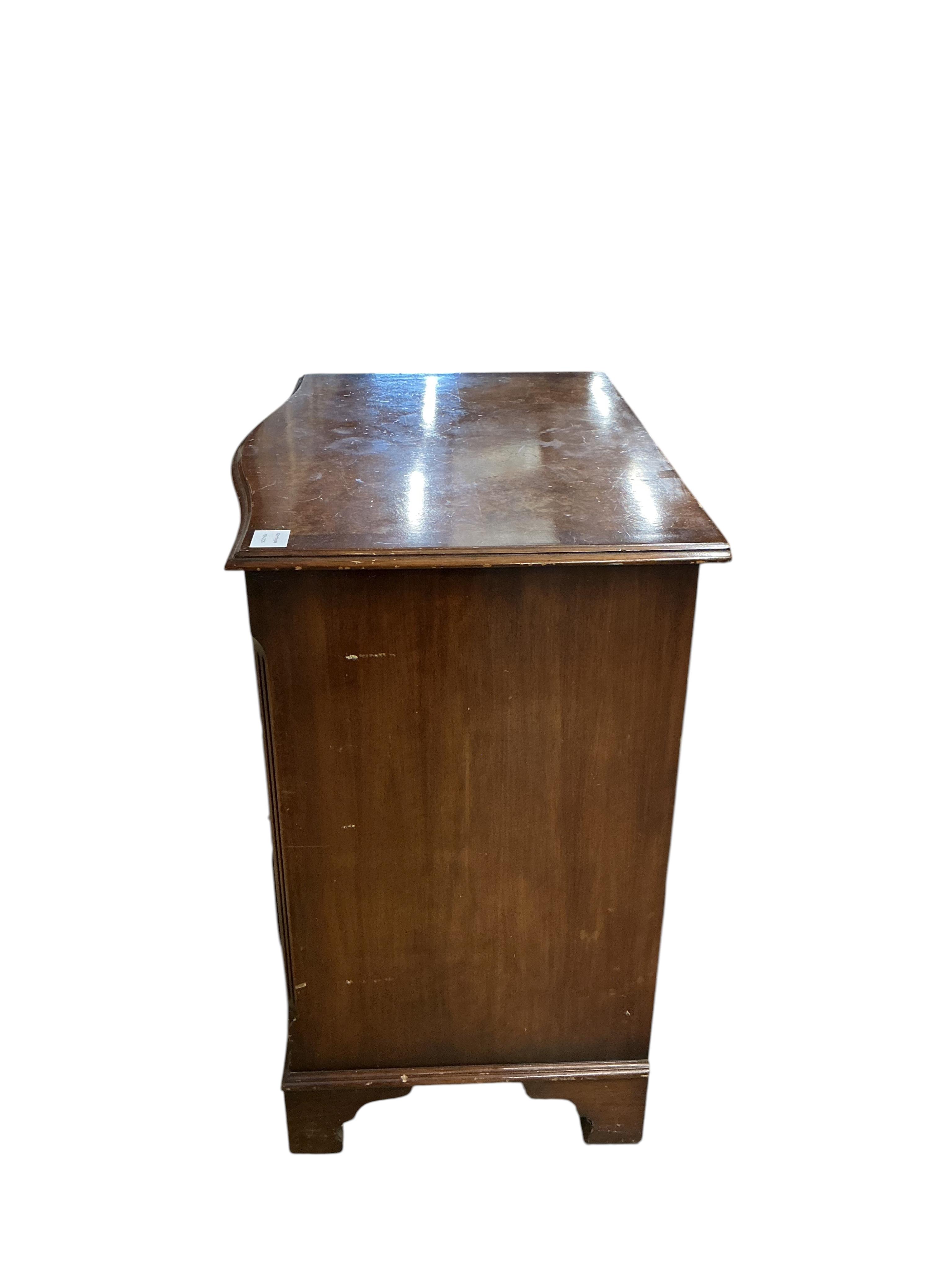A reproduction George I style walnut serpentine four drawer chest, with brushing slide, width 70cm, depth 48cm, height 77cm